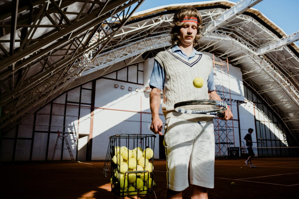 pexels-photo-5739163-5739163 Vintage-inspired image of a tennis player practicing indoors with equipment.